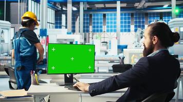 Photovoltaics factory worker analyzing data on green screen PC, reviewing system metrics. Solar panels manufacturing plant employee troubleshooting technical issues using chroma key computer, camera A video