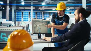 Photovoltaics factory manager delegating tasks to employee, improving solar panels efficiency. Team leader sends worker to make adjustments after researching more sustainable solar solutions, camera A video