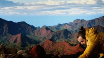 Hiker adventure seeker captures the breathtaking scenic view at the top of mountain, gazes at a distant mountain range and embraces beauty of the wilderness. Joy of discovering wonders. Camera B. video