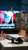 Vertical Black guy meeting with group of individuals on web conference, uses technology for virtual communication. Freelancer working remotely, online meetings or classes in a cozy home. Camera B. video