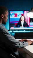 Vertical Network analyst studying digital commerce progression reports on computer, working at home to boost earnings and gain shareholder backing. Specialist analyzes company information. Camera A. video