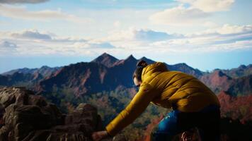 Hiker adventure seeker captures the breathtaking scenic view at the top of mountain, gazes at a distant mountain range and embraces beauty of the wilderness. Joy of discovering wonders. Camera A. video