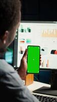 Vertical Financial manager doing accounting work on pc with chroma key screen, examining expenses for legal analysis at home setup. African american advisor working on reducing monthly costs. Camera A. video