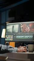 Vertical maker editing montage clips on coloring software at home, working on color correction and motion graphics to edit footage. Content creator editing clips on toolbar panels. Camera A. video