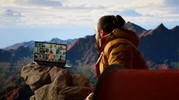 Adventure seeker having internet everywhere and using call discussion, chatting with colleagues on the top of the mountain. Hiker with a technology obsession and dependency. Camera B. video