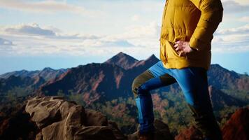 Hiker pauses to admire the panoramic mountain scenery on the hill top, endless sky and rugged peaks creating a breathtaking backdrop for mental clarity. Adventure seeker. Camera A. video