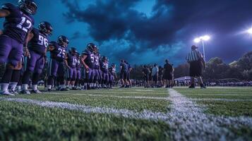 A football team lined up on a field during a game under dramatic skies. photo