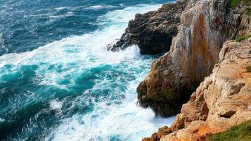 A scenic coastline with crashing waves against rocky cliffs photo