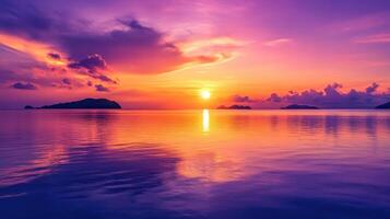 A serene sunset over calm waters, with vibrant purple and orange hues reflecting on the surface. photo