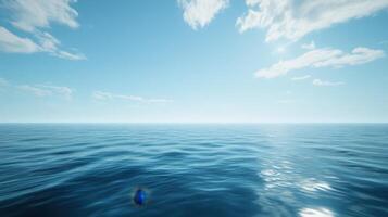 A serene view of a calm ocean under a clear blue sky with scattered clouds. photo