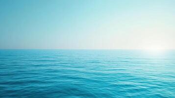 A serene view of calm ocean waters under a clear blue sky photo