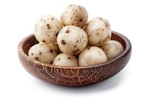 A bowl filled with speckled, white quail eggs photo