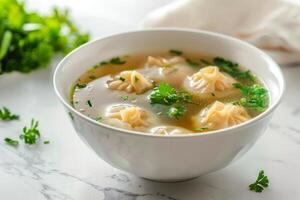 A bowl of soup with dumplings and herbs, showcasing a comforting dish photo