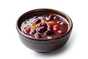 A bowl of sweet red bean soup with various beans in a rich, dark liquid photo