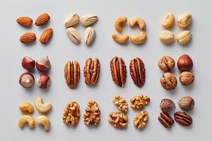 A variety of nuts arranged in an organized layout on a light background photo