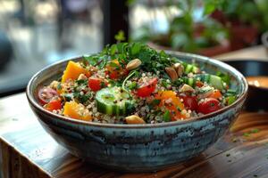 A vibrant quinoa salad topped with fresh vegetables and herbs in a decorative bowl photo