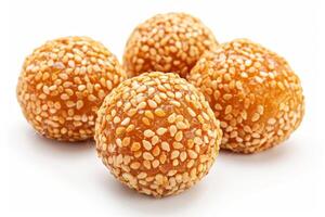 Four golden sesame balls with a crispy texture, often enjoyed as a snack or dessert photo