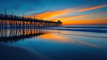 A serene sunset over a pier reflecting on calm waters, creating a tranquil coastal scene photo