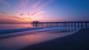 A serene sunset view over a pier extending into calm waters photo