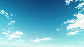 A clear blue sky with scattered clouds, evoking a sense of calm and openness photo