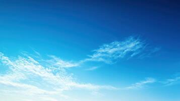 A clear blue sky with wispy clouds, evoking a sense of calm and openness photo