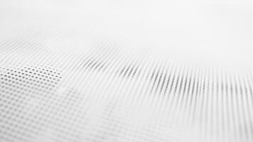 A close-up of a textured surface with a pattern of dots in varying shades of gray. photo