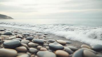 A serene beach scene with smooth pebbles and gentle waves lapping at the shore photo