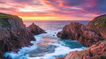 A stunning coastal sunset with rocky formations and gentle waves photo
