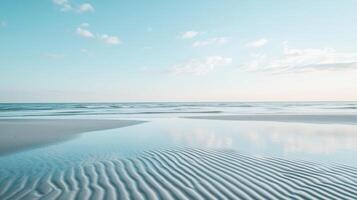 A serene beach scene with gentle waves and a clear sky reflecting on the sand photo