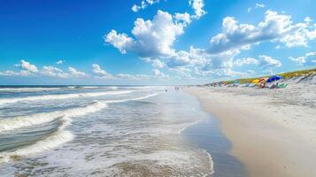 A serene beach scene with waves, umbrellas, and people enjoying the sunny day photo