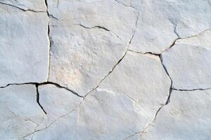 A close up of a cracked wall with cracks photo