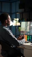 Vertical African American young guy meeting with his boss to discuss task completion, enjoying remote job from the comfort of his modern loft. Waving on a call online, briefing session. Camera A. video