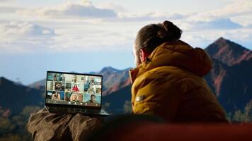 Entrepreneur uses high speed internet connection on mountain top, enjoying the call with a scenic landscape. Young hiker having an internet dependency and being workaholic. Camera B. video