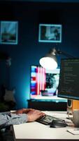 Vertical African american man working on PC to write code and programming in artificial intelligence and deep learning. Male IT engineer using pc to ensure cyber security, neural network. Camera A. video