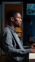 Vertical Operating from home setup, male freelancer evaluating monetary data and searching international capital funds sources to help expand the business. Fiscal analyst validates budget balance. Camera A. video