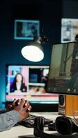 Vertical African American man enjoys conferencing with manager at desk, discussing with his colleague online using a computer at home office setup. Young associates team meeting online. Camera A. video