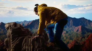 Trekker in warm clothing takes in the sweeping mountain scenic view, feeling the sense of freedom that comes with high altitude exploration. Nature lover enjoys fresh air. Camera A. video