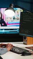 Vertical Developer enters binary data on terminal panel while he establishes html code. Software engineer working from home on troubleshooting with programming language, encryption. Camera B. video