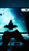 Vertical Guy spends time on television playing multiplayer web games, setting his console into smart tv and having fun gaming at night. Player battling in shooter competition. Camera A. video
