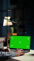Vertical Self employed person checking financial graphs on chroma key screen, researching and sharing insight. Remote worker comparing business graphic economic figures, creating a strategy. Camera A. video