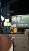 Vertical Male editor working on creative software to create montage, using color correction and adding visual effects. Content creator editing graphics and gradient for movie post production. Camera A. video