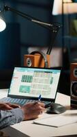 Vertical Black man organizing his schedule with a planner and putting a reminder, creating an adhesive note post it and browsing the web. Modern productive guy writes a memo for research. Camera B. video