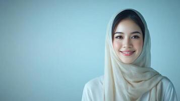 Smiling woman in hijab, soft lighting, studio portrait. photo