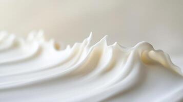 Creamy, smooth, whipped texture of cosmetic cream or lotion. Close-up view of a soft, flowing substance. photo
