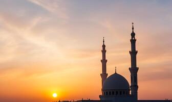 Sunset silhouette of a mosque with two minarets. photo