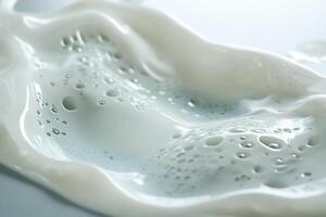 Close-up of creamy liquid with air bubbles, flowing texture. photo