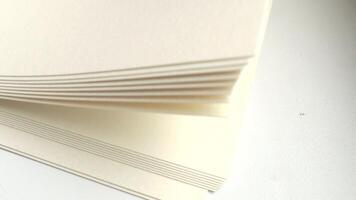 A stack of white paper folded into a square video