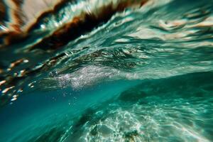 Underwater turquoise wave. Sunlight beams through water, creating a captivating view of a turquoise wave's underbelly. Bubbles and small aquatic life are visible photo