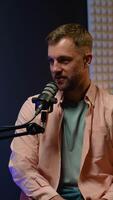Focused podcast host delivering insights and stories during a live radio broadcast video