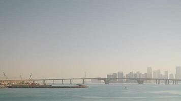 amazing skyline with view of Dubai and large bridge in Persian Gulf, construction area on island video